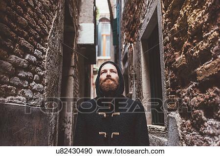 Mid adult man in hooded duffle coat staring from alley, Venice, Italy View Large Photo Image Stock Image - Mid adult man in hooded duffle coat staring from alley, Venice, Italy. Fotosearch