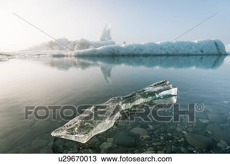 Stock Image - Misty view of ice bergs on glacial lagoon, Jokulsarlon, Iceland. Fotosearch