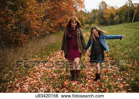 Mother and daughter holding hands walking in meadow, Lakefield, Ontario, Canada View Large Photo Image Stock Photograph - Mother and daughter holding hands walking in meadow, Lakefield, Ontario, Canada. Fotosearch
