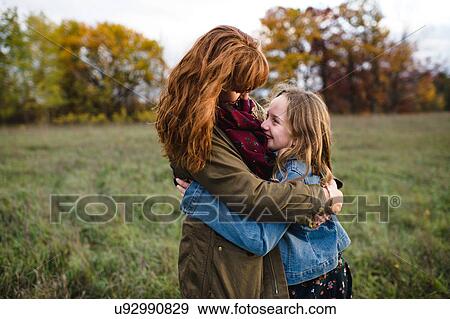 Mother and daughter hugging in meadow, Lakefield, Ontario, Canada View Large Photo Image Stock Photo - Mother and daughter hugging in meadow, Lakefield, Ontario, Canada. Fotosearch