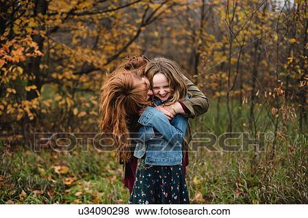 Mother and daughter hugging in wooded area, Lakefield, Ontario, Canada View Large Photo Image Stock Photo - Mother and daughter hugging in wooded area, Lakefield, Ontario, Canada. Fotosearch