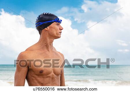 Muscular male swimmer on beach looking away View Large Photo Image Stock Photograph - Muscular male swimmer on beach looking away. Fotosearch