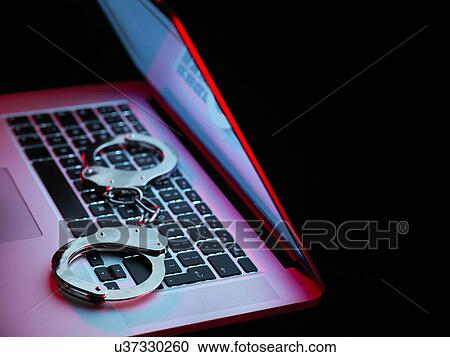 Network security, set of handcuffs sitting on laptop computer View Large Photo Image Stock Image - Network security, set of handcuffs sitting on laptop computer. Fotosearch