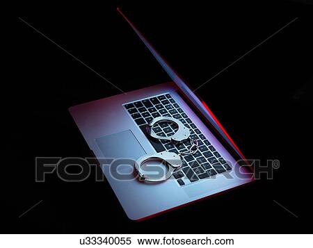 Network security, set of handcuffs sitting on laptop computer View Large Photo Image Stock Photography - Network security, set of handcuffs sitting on laptop computer. Fotosearch