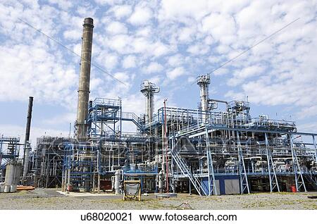 Stock Image - Oil refinery with pipework and chimneys. Fotosearch