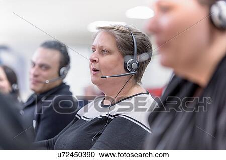 Stock Image - Operators in automotive call centre in car factory. Fotosearch