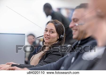 Stock Image - Operators in automotive call centre in car factory. Fotosearch