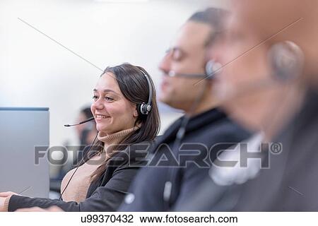 Stock Image - Operators in automotive call centre in car factory. Fotosearch