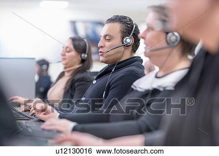 Stock Photograph - Operators in automotive call centre in car factory. Fotosearch