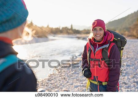 Over shoulder view of two female hikers on lakeside in Bavarian Alps View Large Photo Image Stock Image - Over shoulder view of two female hikers on lakeside in Bavarian Alps. Fotosearch