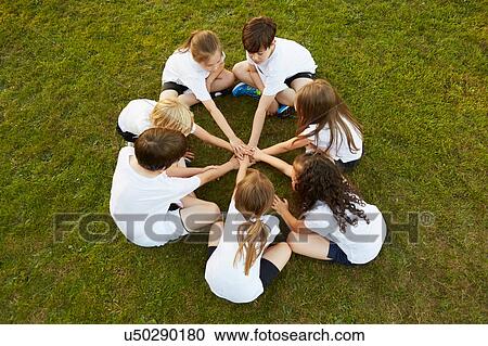 Overhead view of boy and girl sport team sitting on grass in circle on playing field View Large Photo Image Stock Image - Overhead view of boy and girl sport team sitting on grass in circle on playing field. Fotosearch
