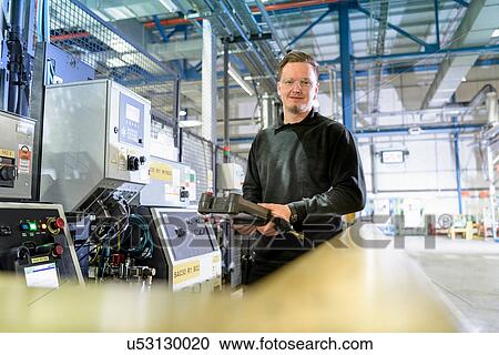 Portrait of apprentice engineer on production line in car factory View Large Photo Image Stock Image - Portrait of apprentice engineer on production line in car factory. Fotosearch
