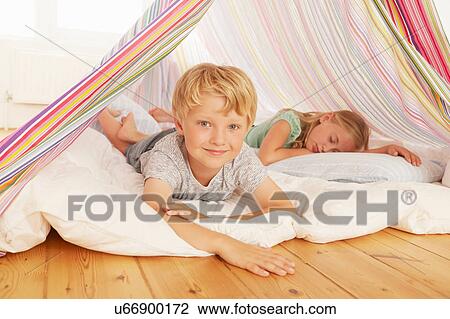 Portrait of boy and sister lying in bedroom tent View Large Photo Image Stock Image - Portrait of boy and sister lying in bedroom tent. Fotosearch