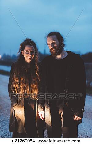Picture - Portrait of couple on roadside at dusk. Fotosearch