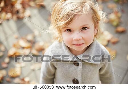 Portrait of cute girl looking at camera View Large Photo Image Stock Image - Portrait of cute girl looking at camera. Fotosearch