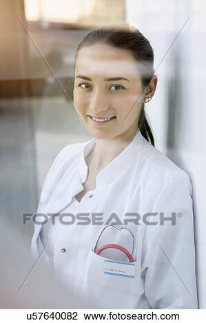 Stock Image - Portrait of female doctor, smiling. Fotosearch