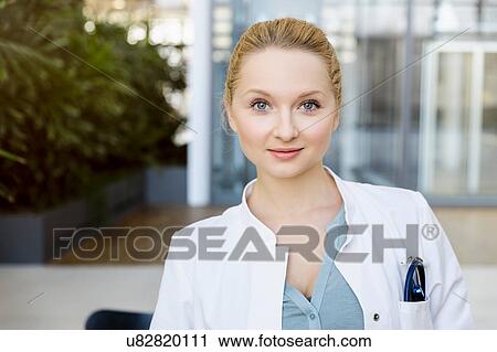 Stock Image - Portrait of female doctor, smiling. Fotosearch