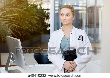 Stock Image - Portrait of female doctor. Fotosearch