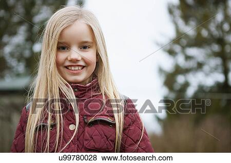 Stock Photo - Portrait of girl with long blond hair outdoors. Fotosearch