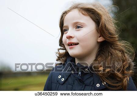 Portrait of girl with long wavy red hair outdoors View Large Photo Image Stock Photo - Portrait of girl with long wavy red hair outdoors. Fotosearch