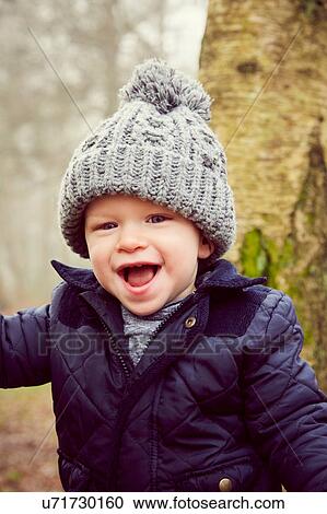 Portrait of male toddler in knitted hat in forest View Large Photo Image Stock Image - Portrait of male toddler in knitted hat in forest. Fotosearch