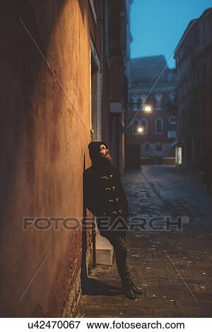 Portrait of man leaning against street wall at dusk, Venice, Italy View Large Photo Image Stock Photo - Portrait of man leaning against street wall at dusk, Venice, Italy. Fotosearch