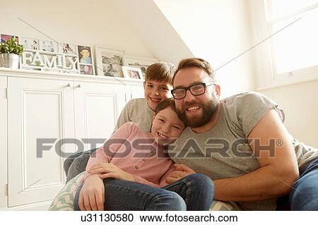 Portrait of mid adult man with son and daughter reclining on beanbag chair View Large Photo Image Stock Image - Portrait of mid adult man with son and daughter reclining on beanbag chair. Fotosearch