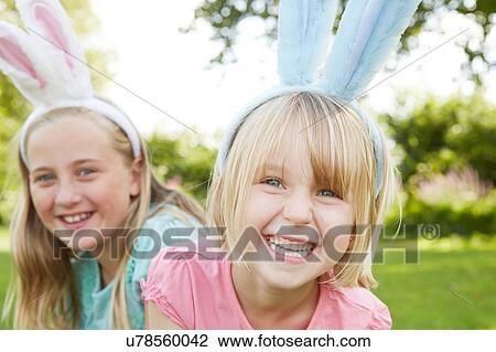 Portrait of two girls in feather headdress in garden View Large Photo Image Stock Image - Portrait of two girls in feather headdress in garden. Fotosearch