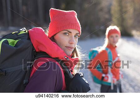 Stock Photograph - Portrait of two women hiking along lakeside in Bavarian Alps. Fotosearch