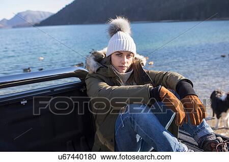 Portrait of woman sitting on pick up at lakeside in Bavarian Alps View Large Photo Image Stock Image - Portrait of woman sitting on pick up at lakeside in Bavarian Alps. Fotosearch