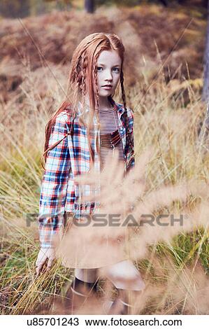 Stock Image - Portrait of young girl in rural setting. Fotosearch