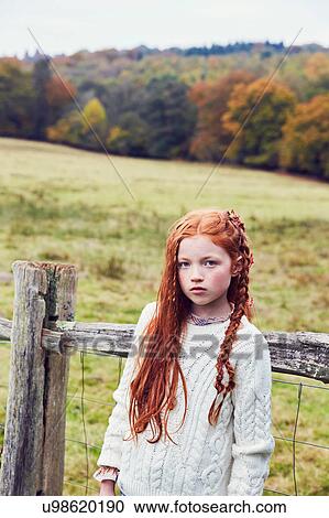 Stock Image - Portrait of young girl in rural setting. Fotosearch