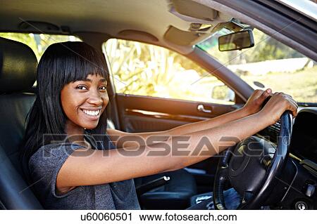 Portrait of young woman driving car View Large Photo Image Stock Image - Portrait of young woman driving car. Fotosearch