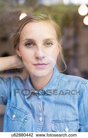 Portrait of young woman gazing through cafe window View Large Photo Image Stock Image - Portrait of young woman gazing through cafe window. Fotosearch