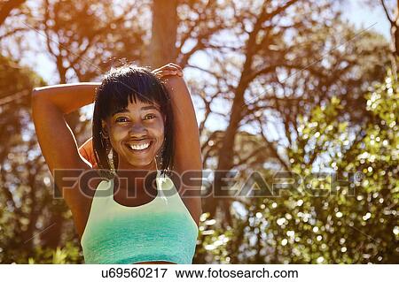 Portrait of young woman in rural setting, exercising, stretching arms View Large Photo Image Stock Photo - Portrait of young woman in rural setting, exercising, stretching arms. Fotosearch