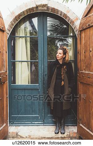 Portrait of young woman looking up from house doorway View Large Photo Image Stock Photography - Portrait of young woman looking up from house doorway. Fotosearch