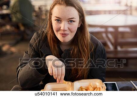 Portrait of young woman, outdoors, eating chips, Bristol, UK View Large Photo Image Stock Image - Portrait of young woman, outdoors, eating chips, Bristol, UK. Fotosearch