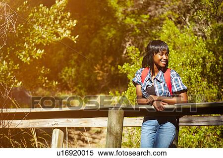 Stock Photography - Portrait of young woman standing on bridge, Cape Town, South Africa. Fotosearch