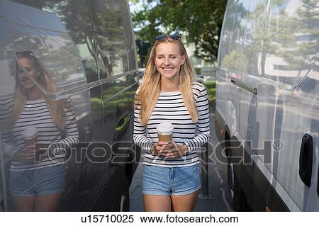 Portrait of young woman with takeaway coffee between parked vans View Large Photo Image Stock Photography - Portrait of young woman with takeaway coffee between parked vans. Fotosearch