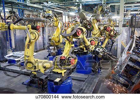 Robots welding body panels on production line in car factory View Large Photo Image Picture - Robots welding body panels on production line in car factory. Fotosearch