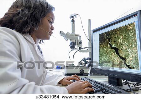 Scientist inspecting metal surface with microscope in laboratory View Large Photo Image Picture - Scientist inspecting metal surface with microscope in laboratory. Fotosearch