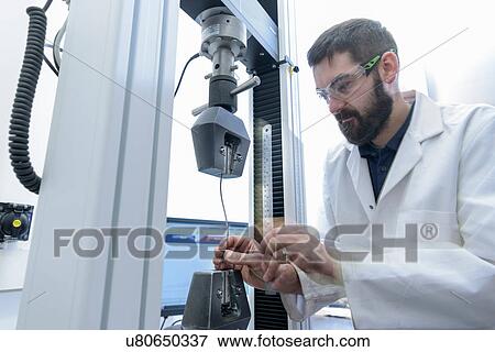 Scientist testing tensile strength of cable in laboratory View Large Photo Image Stock Photo - Scientist testing tensile strength of cable in laboratory. Fotosearch