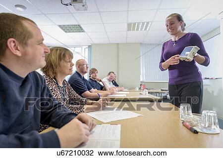 Seminar leader instructing staff members about electrical components View Large Photo Image Stock Image - Seminar leader instructing staff members about electrical components. Fotosearch