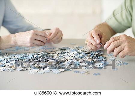 Senior couple doing a jigsaw puzzle View Large Photo Image Stock Photo - Senior couple doing a jigsaw puzzle. Fotosearch