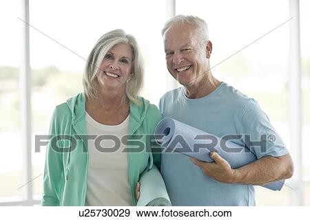 Senior couple holding yoga mats View Large Photo Image Stock Photo - Senior couple holding yoga mats. Fotosearch