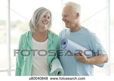 Senior couple holding yoga mats View Large Photo Image Stock Photo - Senior couple holding yoga mats. Fotosearch