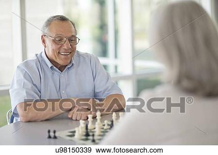 Stock Photo - Senior couple playing chess. Fotosearch