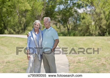 Senior couple standing in park View Large Photo Image Stock Photography - Senior couple standing in park. Fotosearch