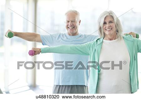 Senior couple using weights View Large Photo Image Stock Image - Senior couple using weights. Fotosearch