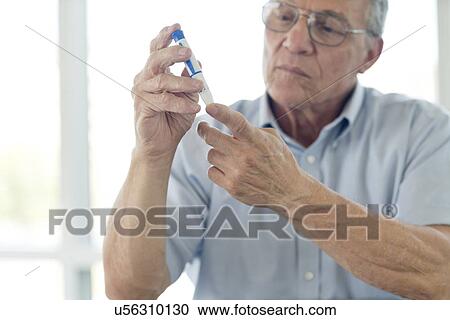 Senior man doing finger prick test View Large Photo Image Stock Image - Senior man doing finger prick test. Fotosearch